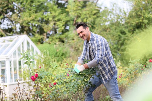 Gardener preparing to bag grass clippings in a terraced garden